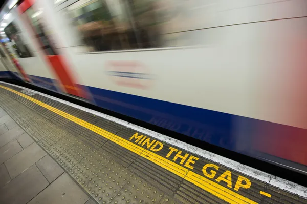 Gap sign with speeding train — Stock Photo, Image