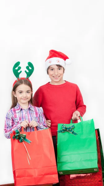 Happy kids wearing Christmas dress holding gifts, isolated on wh — Stock Photo, Image