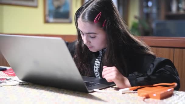 Молода дівчина використовує ноутбук вдома. Концепція домашнього навчання та навчання — стокове відео