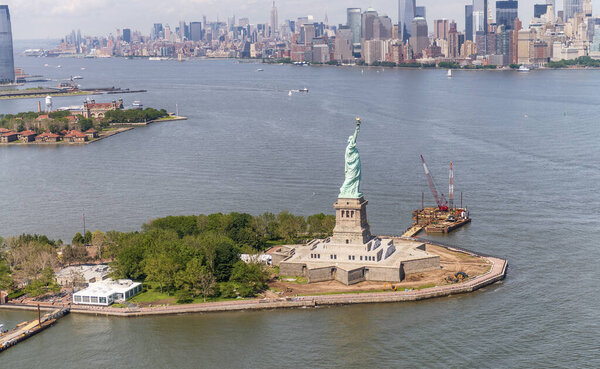 Helicopter view of Statue of Liberty with Lower Manhattan in the background.