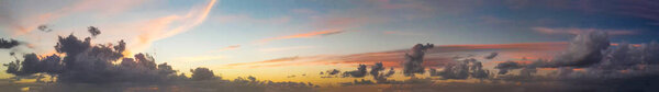 Panoramic aerial view of sunset sky from flying drone