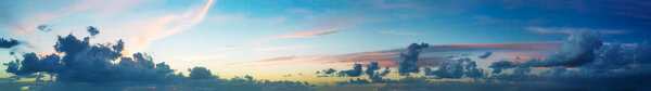 Panoramic aerial view of sunset sky from flying drone