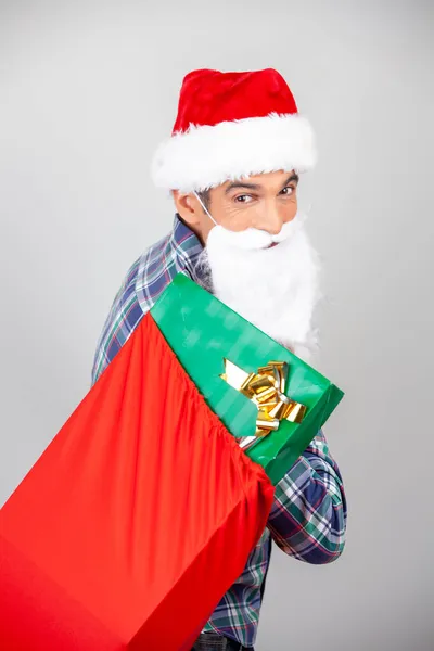 Happy Smiling Man Wearing Christmas Hat Showing Red Gift Boxes — Stock Photo, Image