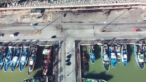 Fishing boats in a small port, aerial overhead view from drone — Stock Video