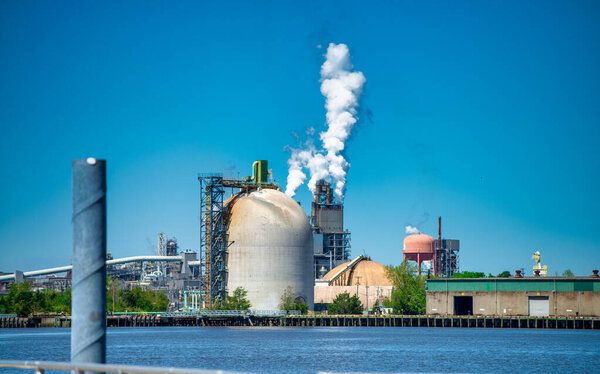 Industrial facility. Exterior of modern petrochemical plant with reactors and converters. Smoke from the chimney