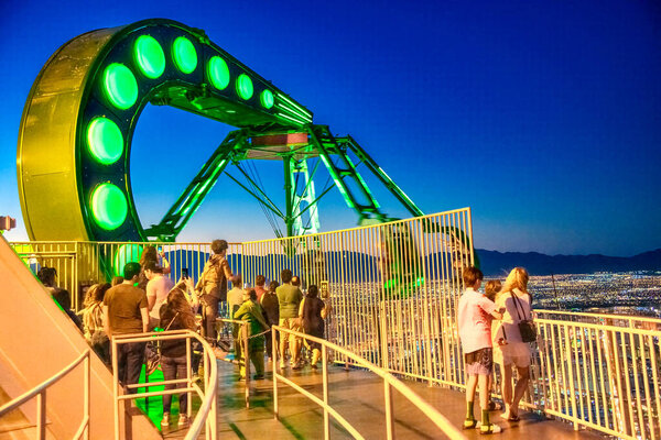 LAS VEGAS, NV - JUNE 30, 2018: Tourists enjoy the city skyline at sunset from hotel rooftop