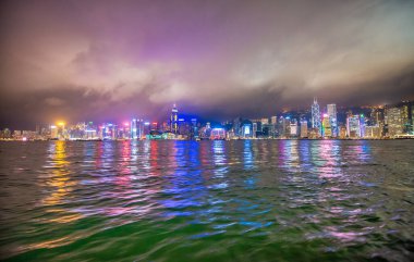 HONG KONG - 5 Mayıs. 2014: Su yansımalarıyla birlikte Hong Kong şehir merkezinin gece silueti