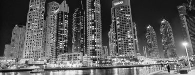 DUBAI, BAE - 5 Aralık 2016: Gece Dubai Marina binaları. Su boyunca gökdelenler