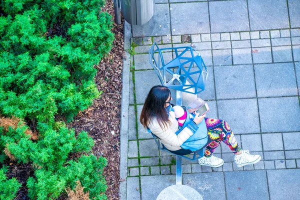 Ovearhead Aerial View Woman Seated Public Bench Using Smartphone — Φωτογραφία Αρχείου