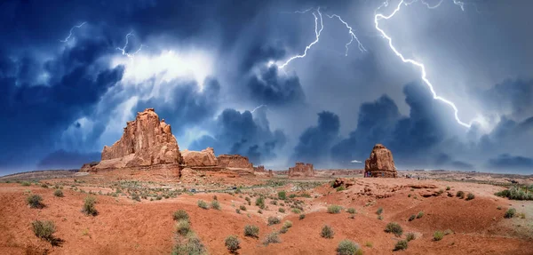 Storm and lightning in the sky over rock formations, Arches National Park, Utah - USA