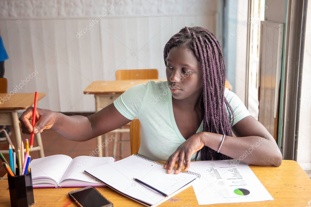African high school girl having test at classroom
