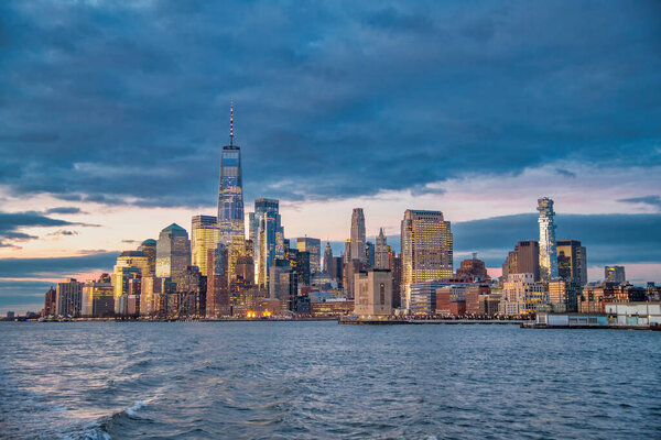 Sunset skyline of Downtown Manhattan as seen from a ferry boat tour around New York City