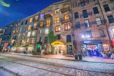 Savannah, Georgia - 1 Nisan 2018: Marsch Adası Kanalı boyunca şehir binaları ve restoranların gece manzarası