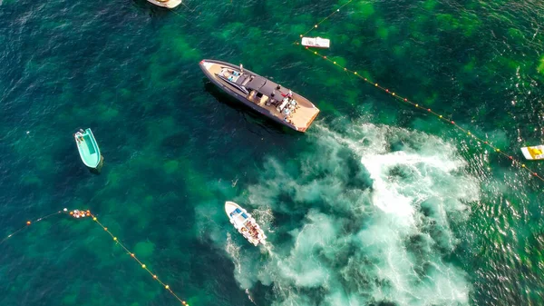 Overhead aerial view of speedboats near the shoreline