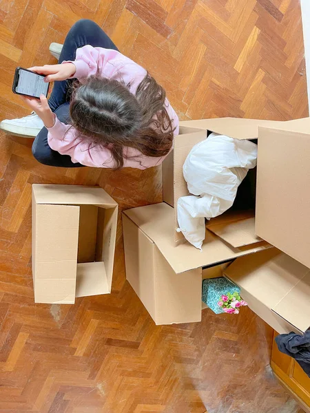 Moving New Home Concept Young Girl Seated Cardboard Boxes Parquet — Φωτογραφία Αρχείου