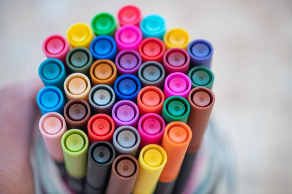 Colorful markers on white background.
