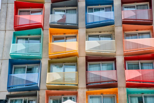 Colorful terraces of a modern tall building.