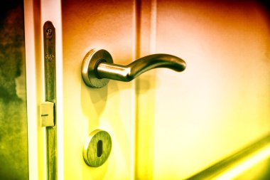 Modern silver door handle in a modern apartment.