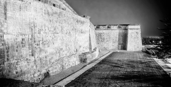 Ancient castle walls of La Valletta at night, Malta.