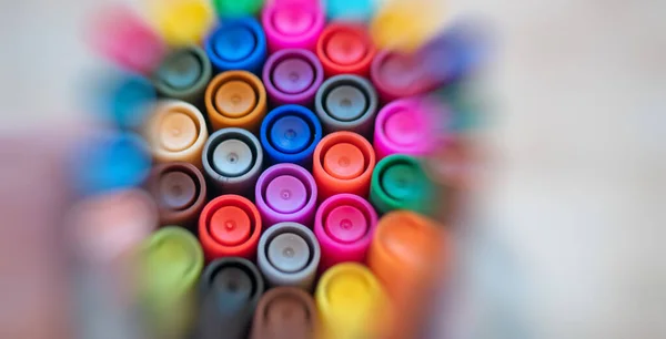 Colorful markers on white background.