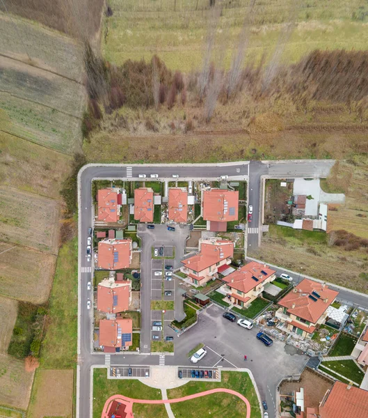 Houses in suburb at summer, overhead aerial view from drone. Luxury houses with nice landscape, image composition, new village concept.