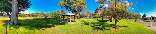 Panoramic view of a beautiful city park and playground on a sunny day.