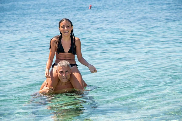 Happy Man Takes His Daughter Piggyback Ride Beach — 图库照片