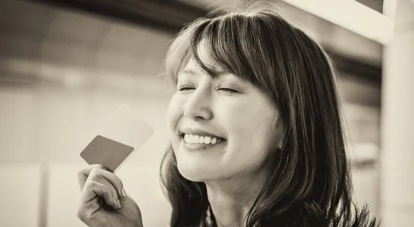 Asian girl happy with credit card.