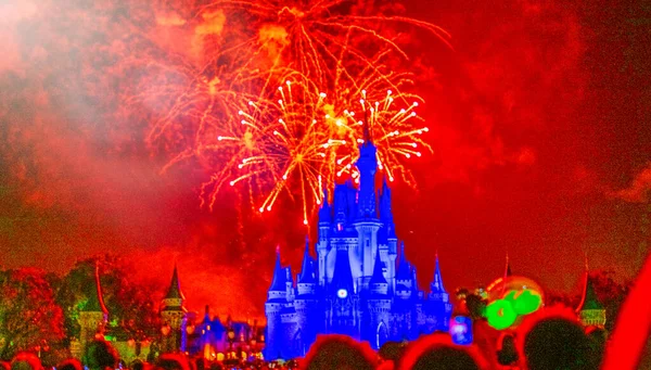 stock image Illuminated castle with people looking at it in the night