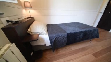 Clean towel on single bed in modern interior bedroom