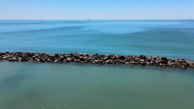 Beautiful aerial view of blue ocean and rocks. Slow motion footage