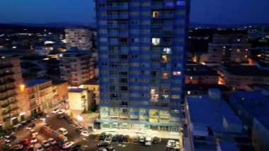 Aerial view of city streets and buildings along the ocean from drone viewpoint.