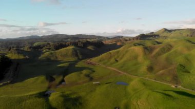 Countryside hills aerial view from drone at sunset, New Zealand.