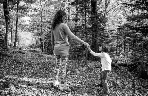 快乐的母亲和女儿在树叶繁茂的季节沿着小径散步 — 图库照片