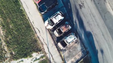 Aerial view of burned cars in a car parking. Terrorist attack and urban danger concept.
