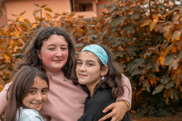 Three Young Girls Embracing Outdoor — Stock Photo, Image