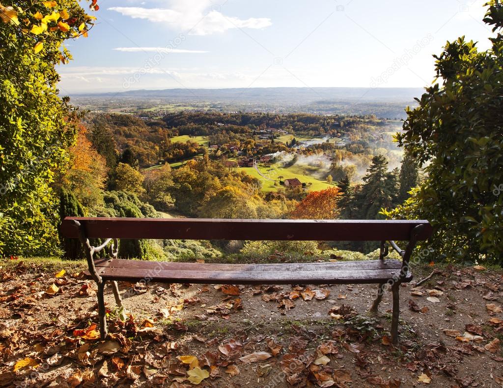 Bench in a park with views of the countryside.
