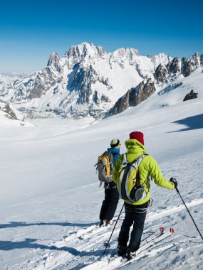 Skiers on the big glacier of Vallee Blanche. clipart