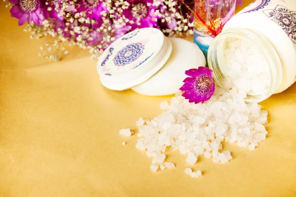 Jar of bath sea salt, soap and violet flowers on old paper backg — Stock Photo, Image