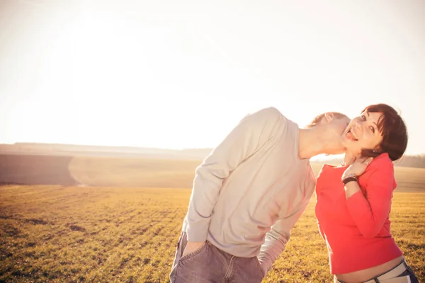 Light portrait of young beautiful couple in love on the spring f — Stock Photo, Image