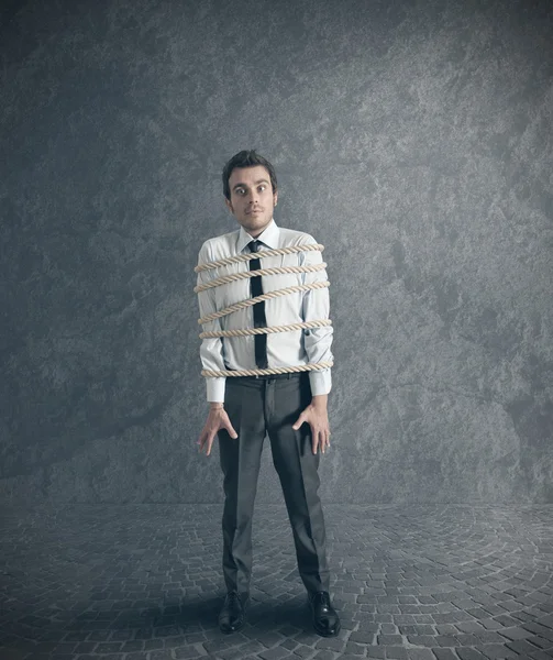 Businessman tied with rope — Stock Photo, Image