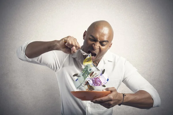 Geld essen — Stockfoto