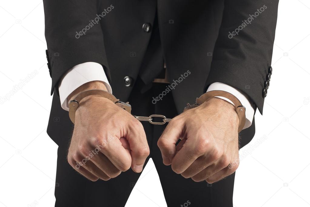 Businessman handcuffed