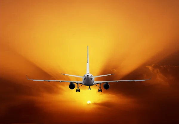 Airplane on sunset sky — Stock Photo, Image