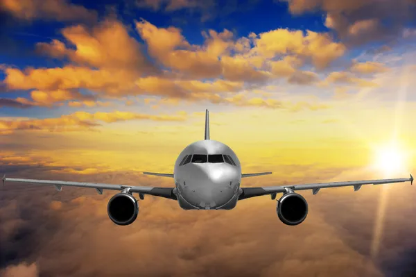 Airplane on sunset sky — Stock Photo, Image