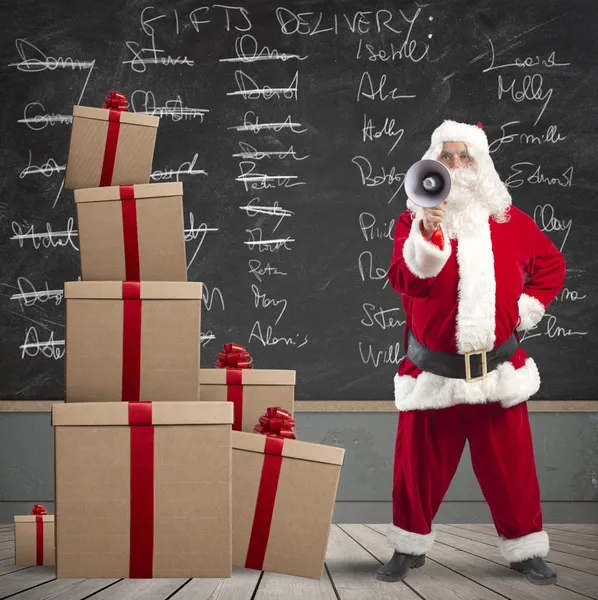 Santa Claus and list of gifts delivery — Stock Photo, Image