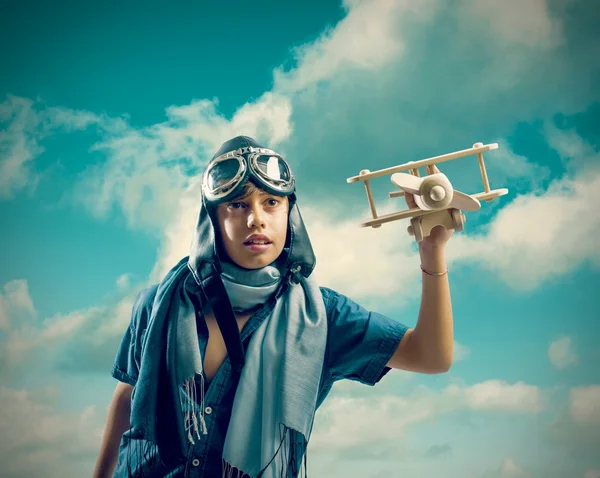 Happy kid playing with toy airplane — Stock Photo, Image