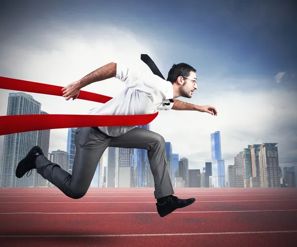 Successful businessman in a finishing line — Stock Photo, Image