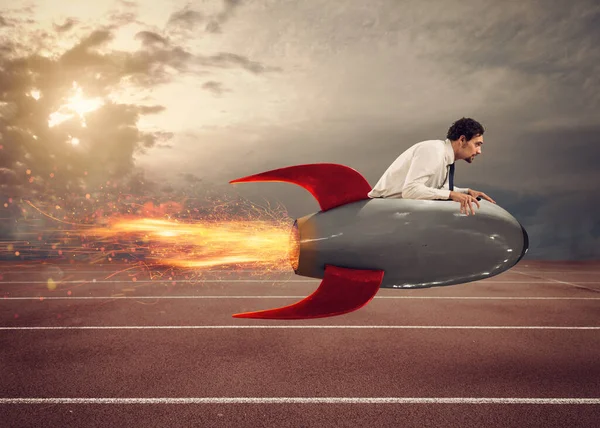 Businessman drives a fast rocket to win a challenge — Stock Photo, Image