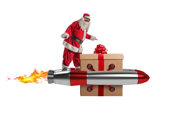 Santa claus delivers gifts with a fast space rocket — Stock Photo, Image